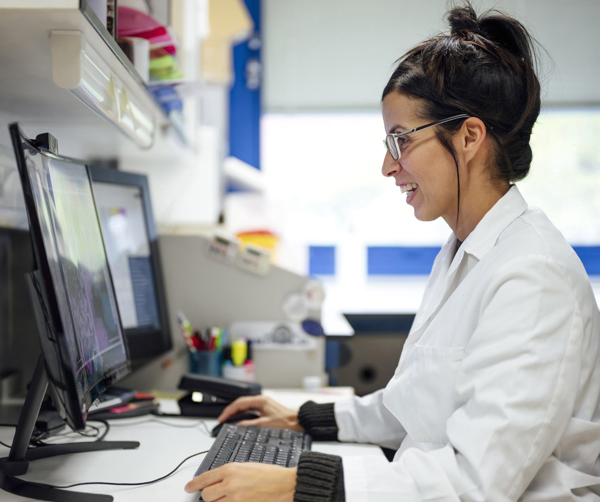 Lab scientist working at a computer workstation